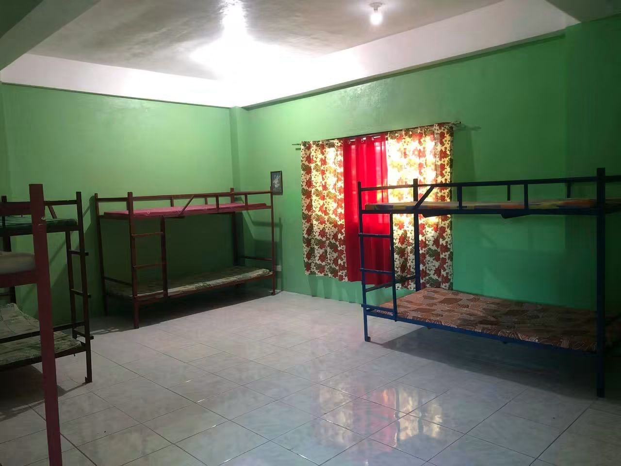 Bed spacer room at GINEL's Dormitory with several bunk beds and a bright window